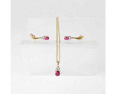 A 9ct white gold mounted claw set ruby with three tiny bezel set diamonds to the top, suspended on a 9ct gold dainty chain wi