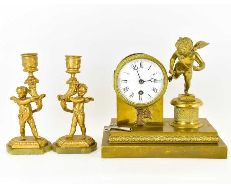 A late 19th/early 20th century French brass table clock, the circular white enamelled dial set with Roman numerals and key wi