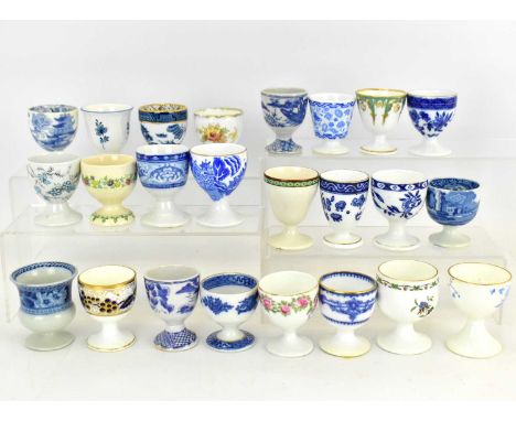 Twenty-four assorted late 19th/early 20th century egg cups, mostly blue and white and floral pattern, makers including Doulto