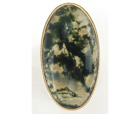 A 9ct gold dress ring with large oval moss agate bezel set stone on large branch shoulders, size T/K, approx. 9g.