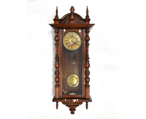 A large walnut cased spring-driven Vienna wall clock, with architectural arched pediment and finials, the dial set with Roman