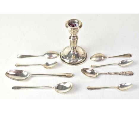 A small quantity of silver items, comprising a chamber stick with loaded base, various spoons including a souvenir spoon for 