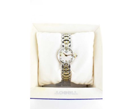 TISSOT; a ladies' vintage wristwatch, the mother of pearl dial set with raised Roman numerals at quarters, on a bi-colour sta