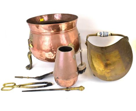 A 19th century copper and brass coal bucket with lion mask handles, raised on three brass supports with lion claw feet, heigh