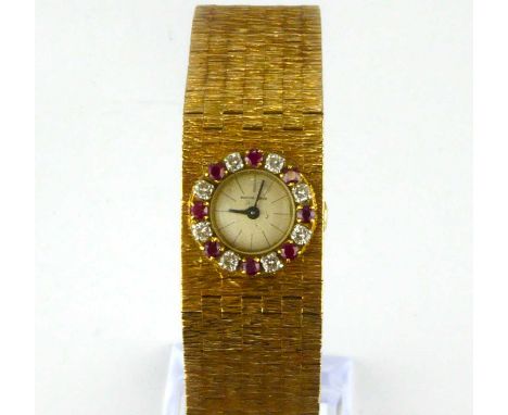 BUECHE-GIROD; a ladies' 9ct gold vintage wristwatch, the small circular dial set with single line increments, bezel set with 