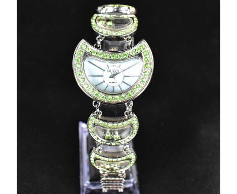 A vintage ladies' bracelet wristwatch, the crescent-shaped dial marked 'Gucci quartz' and set with graduated baton numerals, 