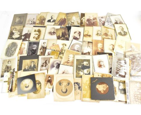 A collection of early 20th century photograph portrait cards, mainly black and white.