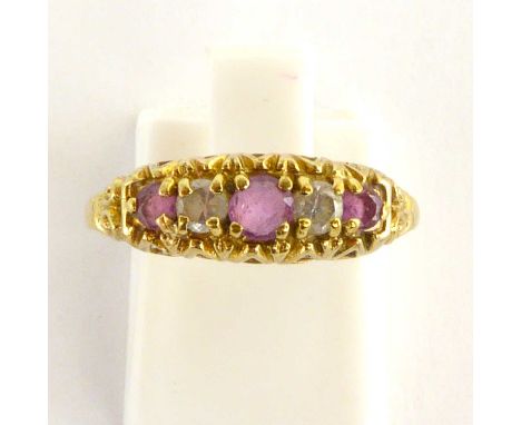 A 9ct gold dress ring with three claw set amethysts separated by two small white stones, size L, approx. 1.9g.