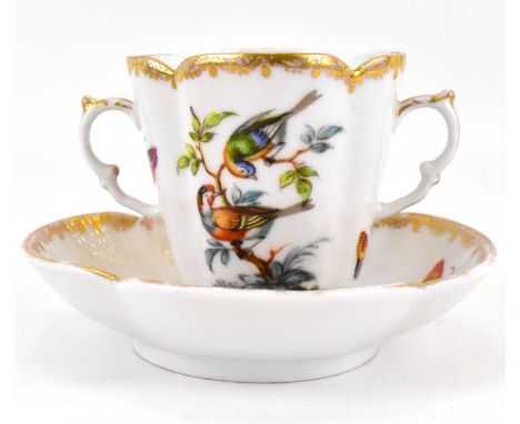 DRESDEN; a late 19th century Meissen-style chocolate cup and saucer decorated with exotic birds, insects and shrubs, with ear