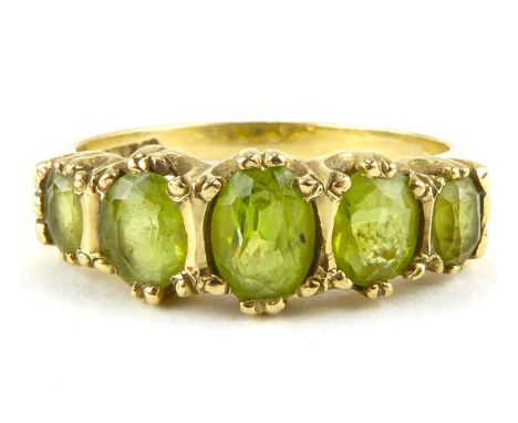 A 9ct gold dress ring set with five graduated cut peridots, size M, approx. 2.7g.