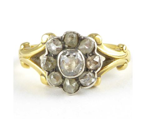 A vintage 18ct gold diamond cluster ring, the central bezel set diamond approx. 0.2ct, surmounted by eight small bezel set ro