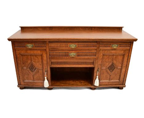 An early 20th century oak sideboard with bank of two drawers over open storage, flanked by single drawer over cabinet, 95 x 1