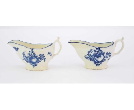 Two Caughley 'Apple and Damsons' sauceboats, circa 1780, of strap-fluted form with scalloped rim, transfer-printed in undergl