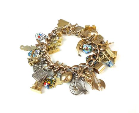 A 9ct rose gold curb link bracelet, with bolt ring clasp and attached 9ct gold, yellow metal, gilt metal and white metal char
