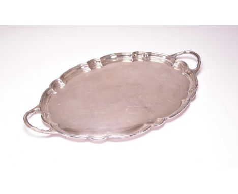 A large two handled silver tray, Harrison Brothers &amp; Howson, Sheffield 1918, of lobed oval form, 66cm wide (including han