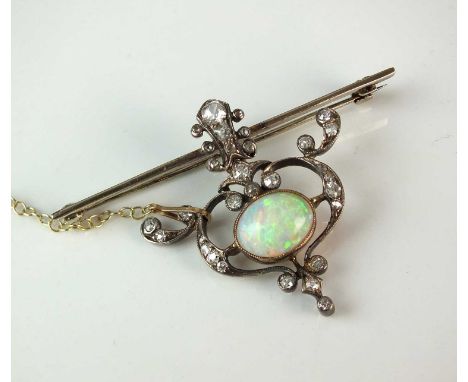 An early 20th century opal and diamond brooch, designed as a central oval cabochon opal milligrain set within an openwork scr