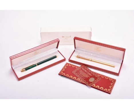 Two Must de Cartier ballpoint pensThe first gold plated with engine turned finish, the second in jade style lacquer with gold