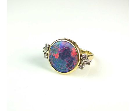 An opal doublet ring and diamond ring, designed as a central circular opal doublet mounted in yellow metal and flanked to eac