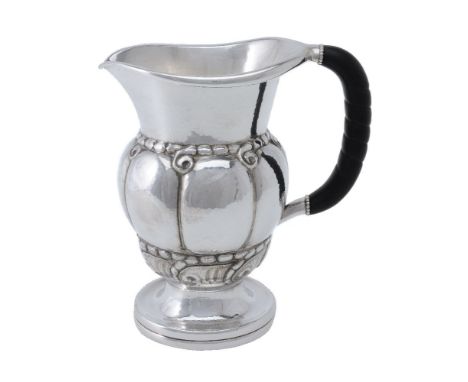 ϒGeorg Jensen, a Danish silver water jug or pitcher, post 1945 stamped marks, design no. 7, with an ebony handle, 20cm (8in) 