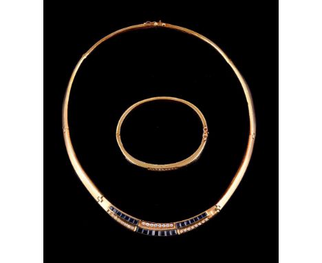 A diamond and sapphire necklace and bangle, the necklace with a central panel set with alternating curved rows of graduating 