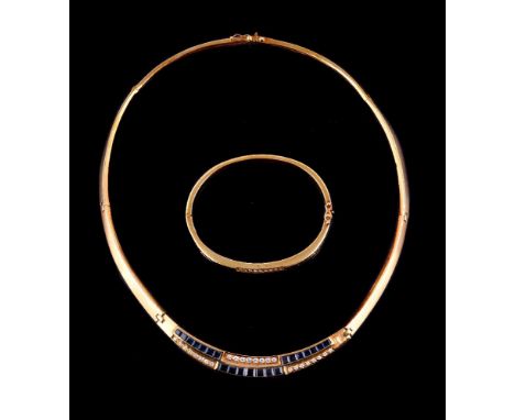 A diamond and sapphire necklace and bangle, the necklace with a central panel set with alternating curved rows of graduating 