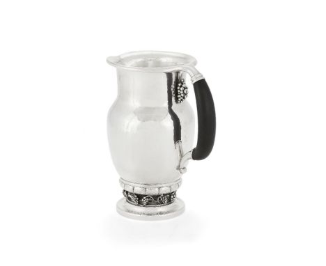 ϒGeorg Jensen, a Danish silver Grape pattern pitcher or jug, post 1945 stamped mark, design no. 407A, with an ebony handle, 2