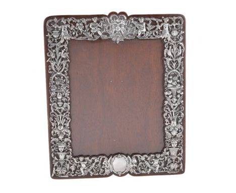 A Victorian silver photograph frame by William Comyns &amp; Sons, London 1887, shaped rectangular, pierced and embossed with 