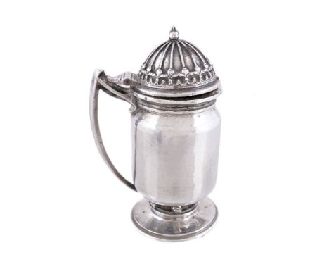 An Arts and Crafts hammered silver mustard pot by Omar Ramsden, London 1935, engraved beneath Omar Ramsden Me Fecit, cylindri