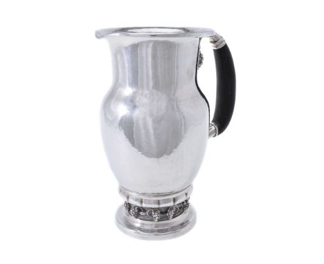 ϒGeorg Jensen, a Danish silver Grape pattern pitcher or jug, post 1945 stamped mark, design no. 407A, with an ebony handle, 2