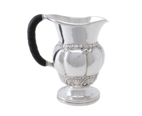 ϒGeorg Jensen, a Danish silver water jug or pitcher, post 1945 stamped marks, design no. 7, with an ebony handle, 20cm (8in) 