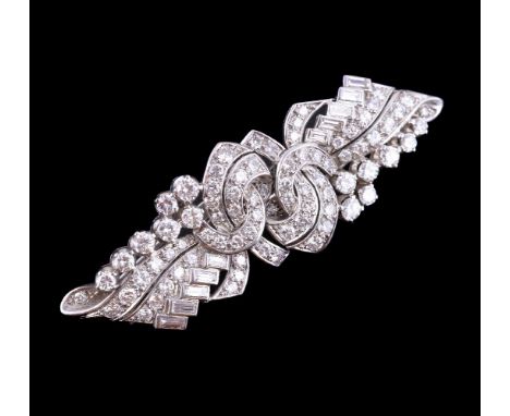 A 1950s diamond double clip brooch, the geometric pierced bow panels set with brilliant cut and baguette cut diamonds, approx