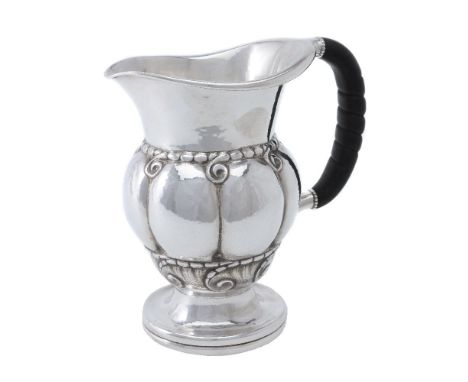 ϒGeorg Jensen, a Danish silver water jug or pitcher, post 1945 stamped marks, design no. 7, with an ebony handle, 20cm (8in) 