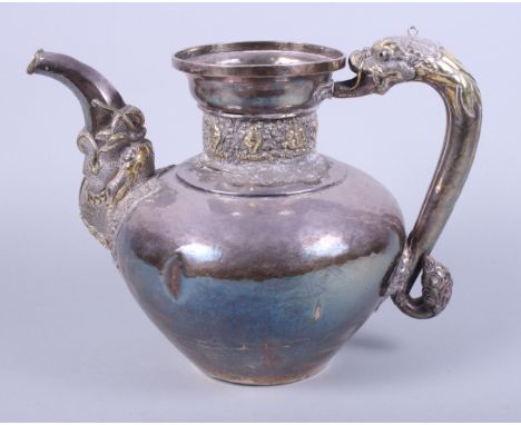 An early 20th century Indian white metal hot water pot with cast serpent handle, elephant trunk spout and slight hammered fin