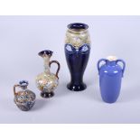 A Doulton Lambeth ewer with "C" scroll handles, leaf and flower decoration, 5" high and three