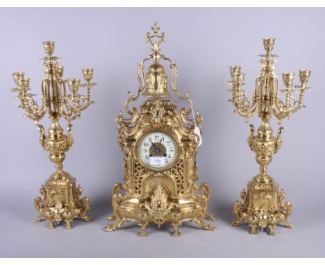 A French late 19th century gilded brass three-piece clock garniture by H Luppens, Paris, the white enamel dial painted with b