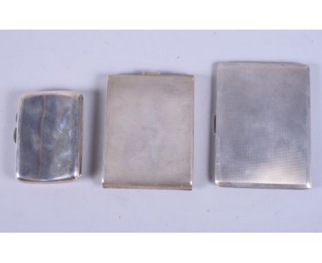 A sterling silver cigarette case with engine turned decoration, together with two other cigarette cases, 12oz troy approx