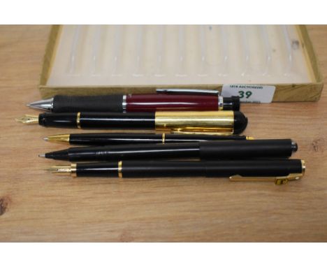 Two fountain pens, two ball point pens and a fibre tip. A Sheaffer fashion fountain pen in matt black, an Aurora fountain pen