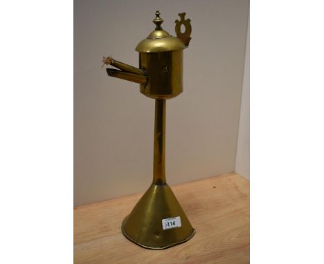 A primitive antique brass taper lighter or similar.