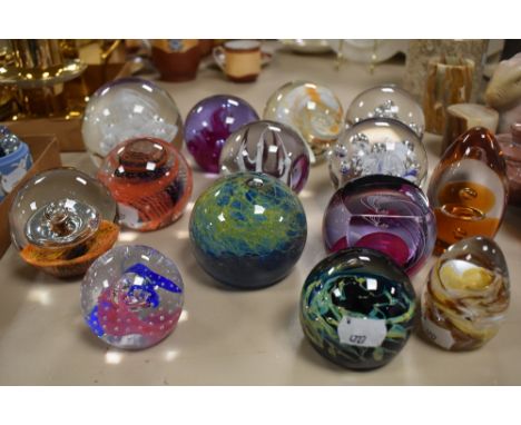 An assorted collection of art glass paperweights, by Caithness glass, and others