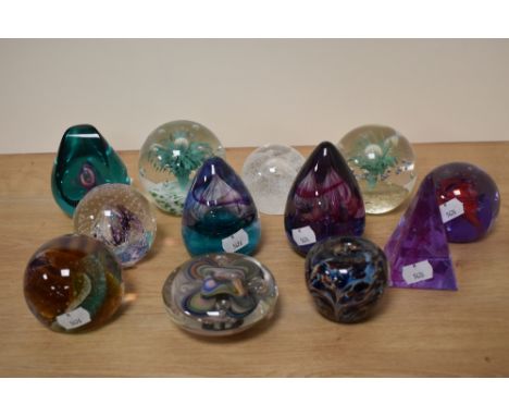 Twelve paperweights, many Caithness, including controlled bubble and Adrian Sankey paperweight of apple form.
