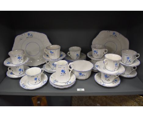 A collection of Art Deco Victoria bone china cups and saucers, plates, jug and cake plates, having blue floral pattern.
Some 
