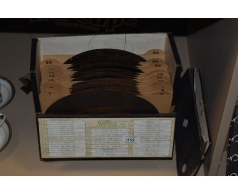 A collection of metal Phonograph 'discs' in a carry case.
