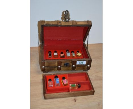 A 20th Century novelty trinket box, in the form of a treasure chest, containing scent bottles
