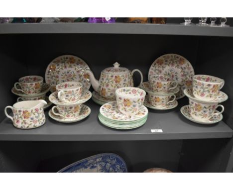 A selection of Minton 'Haddon Hall' plates, teapot, cups and saucers, milk and sugar.