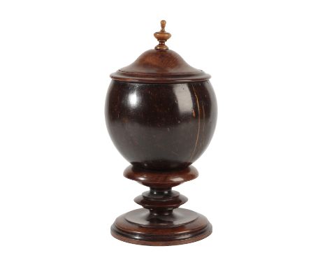 STAINED COCONUT AND TREEN MOUNTED JAR, 19th century, the domed cover with turned urn finial and ogee moulded collar, above a 