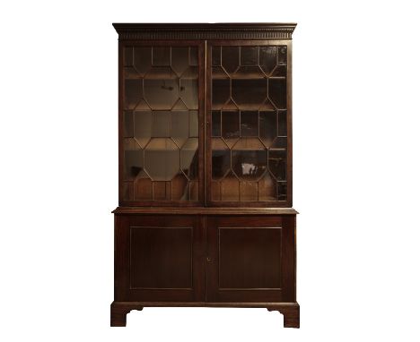 MAHOGANY AND GLAZED CABINET BOOKCASE IN GEORGE III STYLE, later 19th century, with dentil moulded and fluted cornice above tw