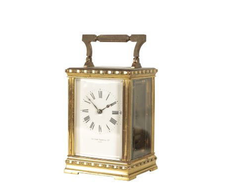 FRENCH BRASS CASED STRIKING CARRIAGE CLOCK, the white enamel dial with Roman numerals, inscribed "Sir John Bennett Ltd Paris"