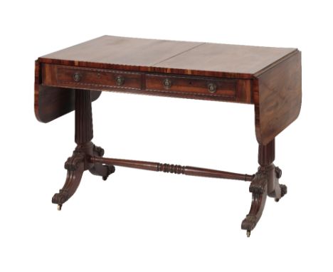 REGENCY GONCALO ALVEZ SOFA TABLE, circa 1815, with rectangular top and drop-leaf ends, the front with twin drawers with brass