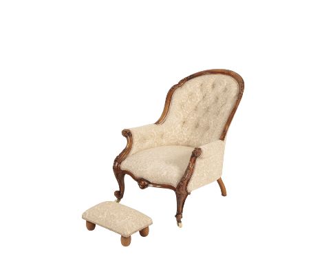VICTORIAN CARVED WALNUT AND BUTTON UPHOLSTERED SPOONBACK ARMCHAIR, circa 1865, the arched toprail, arm rest terminals and cab