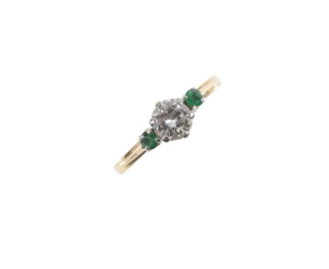 A DIAMOND AND EMERALD RING, the brilliant cut diamond, estimated to weigh 0.65 carats, between two circular cut emeralds, sta